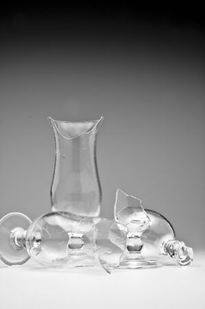 Dangerous still life with three empty modern broken / shattered glasses on a tableの写真素材