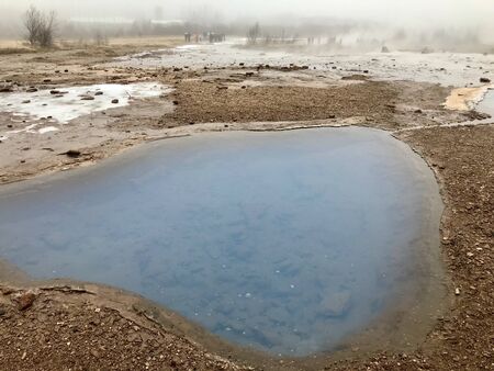 The Blesi Northern Pool, part of Haukadalur, the home of geysers and other geothermal features along the Golden Circle tourist trail in Southern Iceland on a foggy autumn afternoonの写真素材