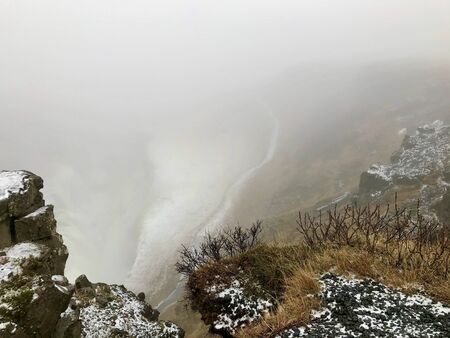 Majestic landscape of Gullfoss (golden waterfall) in Iceland on a cold November day: Outdoor scenery with water flowing down rocks and cliffs in a beautiful wild park in arctic North Europeの写真素材