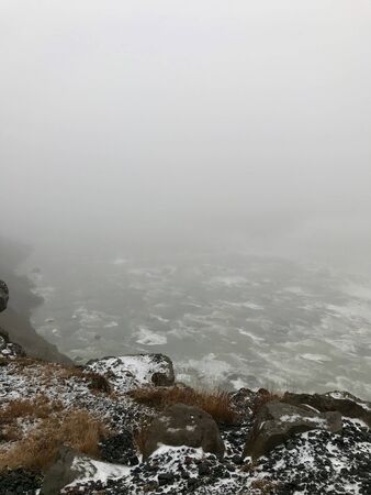 Majestic landscape of Gullfoss (golden waterfall) in Iceland on a cold November day: Outdoor scenery with water flowing down rocks and cliffs in a beautiful wild park in arctic North Europeの写真素材