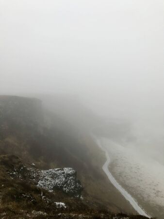 Breathtaking scenery at the Gullfoss Golden Waterfall landmark, a nature attraction in Iceland: Arctic nature with majestic rocks, the Hvita river running in the winter canyon with a cloudy white skyの写真素材