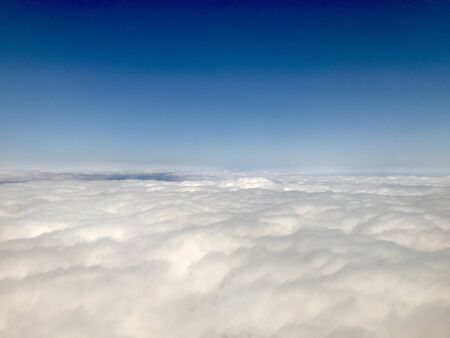 Beautiful heavens gate high above the clouds: Idyllic aerial view from a airplane window with a...