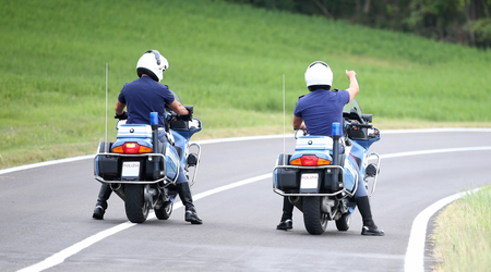 two police man standing in the middle of the street on theire motorbikeの写真素材