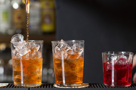 closeup of a barmaid preparing cocktails on the bar counter 