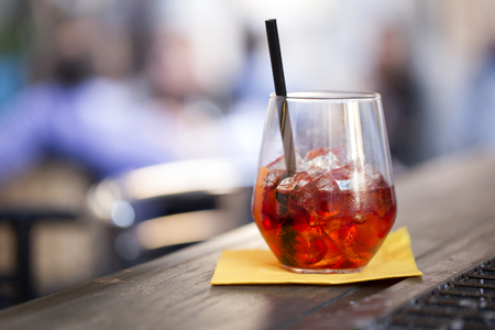 closeup of a glass of red juice on a bar counter, subject on the rightの写真素材