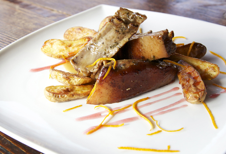 tender and succulent little piggy with baked vegetables with citrus flavorの写真素材