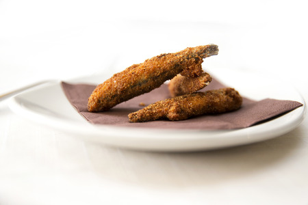 deep fried crisp sardines on a brown napkinの写真素材