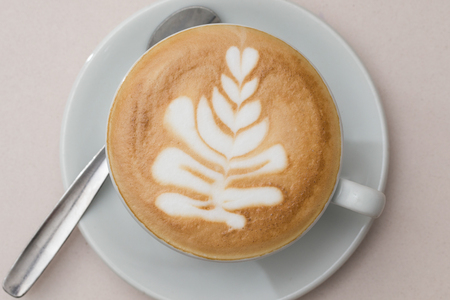 top view of a cup of cappuccino with a latte-art decorationの写真素材