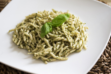 closeup of a plate of trofie al pesto ready to eatの写真素材