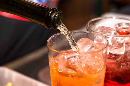 Horizontal close up of a barman making a spritz on the bar counter.の写真素材