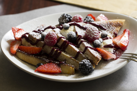 slices of bread with cream in it and fresh fruitsの写真素材