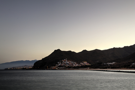 A San Andres and Santa Cruz landscape from Las Teresitas beach in the Tenerife island at the sunsetの写真素材