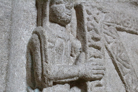 A close view of a stone low relief of a woman holding a shieldの写真素材
