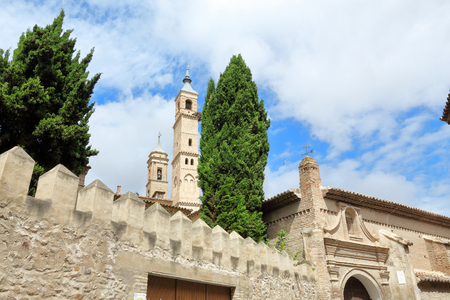 The bell tower of the Holy Mary Collegiate ( Colegiata de Santa Maria), seen from the Calle Goya street in Borja, a small Aragonese town in Spainの写真素材