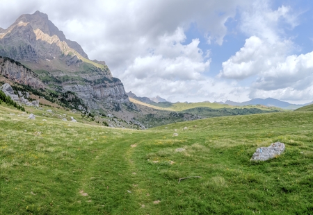 The mountains and the massif along the green path to the Piedrafita de Jaca lake in the aragonese Pyrenees mountainsの写真素材