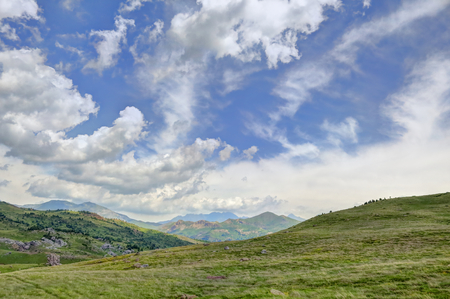 The mountains and the massif along the green path to the Piedrafita de Jaca lake in the aragonese Pyrenees mountainsの写真素材