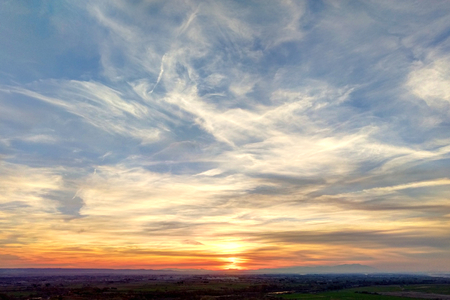 A sunset in a sunny day with a blue sky and clouds in the Galacho del Juslibol rural area, Zaragoza, Aragon region, Spainの写真素材