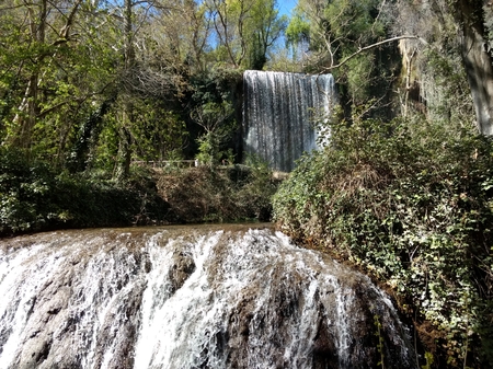 Two waterfalls among green trees and rocks in the Monasterio de Piedra natural park in Nuevalos, Aragon region, Spainの写真素材