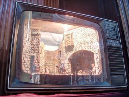 Galliate, Italy - December 26, 2016: An Italian Christmas nativity scene (presepe) with miniature building represented inside an old cathode ray tube televisionのeditorial素材