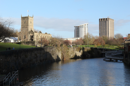 A landscape of the Avon river in front of the rumbled Saint Peter's Church in the Castle Park from the Bristol Bridge in the Bristol, United Kingdomのeditorial素材