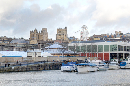 Bristol, United Kingdom - November 30, 2018: The Bristol Cathedral and wharf on the Avon river from Museum promenade in Spike Island, in a cloudy winter, with some boats, United Kingdomのeditorial素材