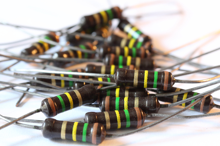 A heap of multicolored brown resistors with 150 KOhm resistance and 1 Watt power dissipation, with axial horizontal through hole mount, with pinsの写真素材