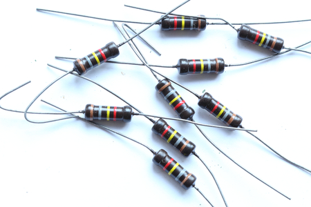 A heap of multicolored brown resistors with 180 KOhm resistance and 1 Watt power dissipation, with axial horizontal through hole mount, with pinsの写真素材