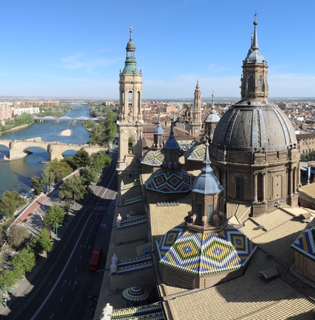 A landscape of Zaragoza with the Puente de Piedra and Puente de Hierro bridges, the Ebro river and a Pilar Cathedral bell tower, in Aragon, Spainの写真素材