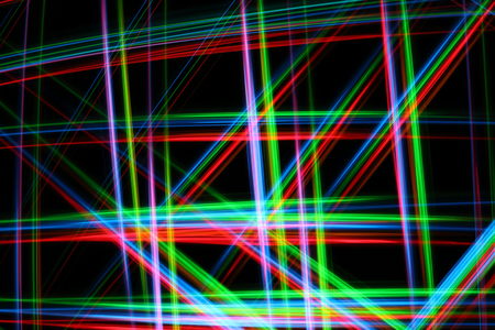 A colorful and glowing light painting abstract image with red, green, blue and yellow blurry lines over a black background, creating a netの写真素材
