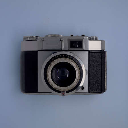 A vintage camera with isolated blue background