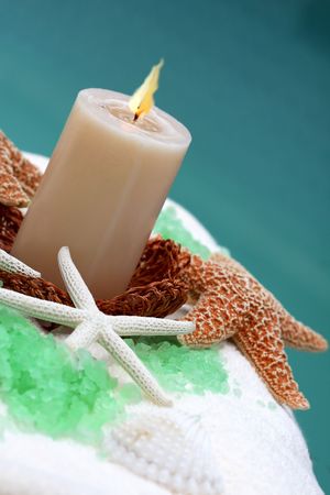 Candle and spa item on white towel の写真素材