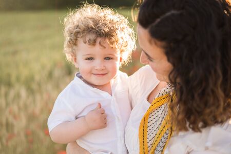 mother in nature with baby son in the arms.の写真素材