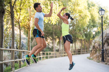 young people enjoy exercising outdoors and post give me fiveの写真素材