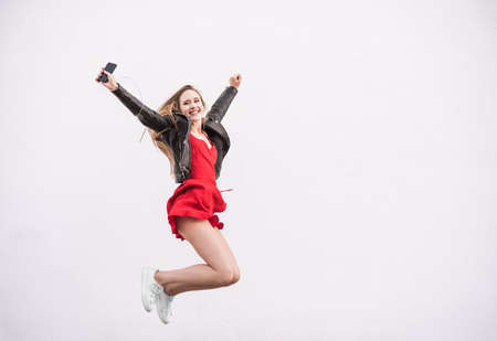 Happy Caucasian Teenager Jumping on White Urban Background