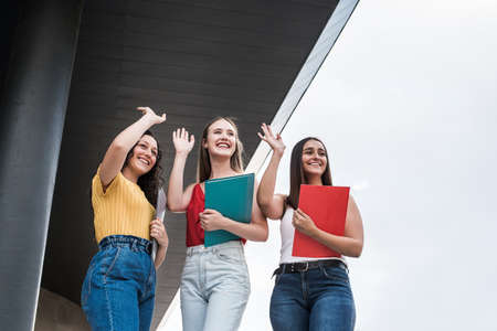 Smiling young women greet in the distanceの写真素材