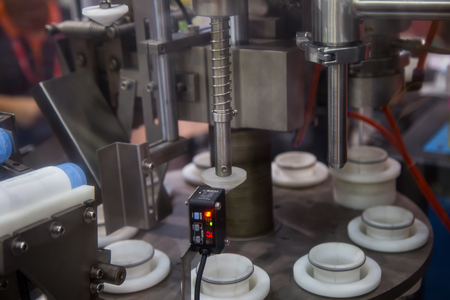 Close-up of automatic bottle capping machine