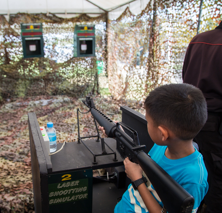 Asian boy shoot laser simulator machine gun