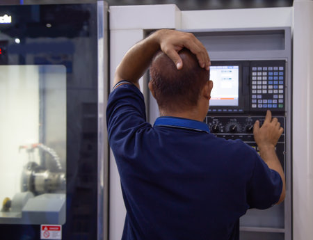 Industrial worker input data programing for CNC lathing machineのeditorial素材