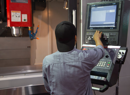 Industrial worker input data programing for CNC milling machineのeditorial素材