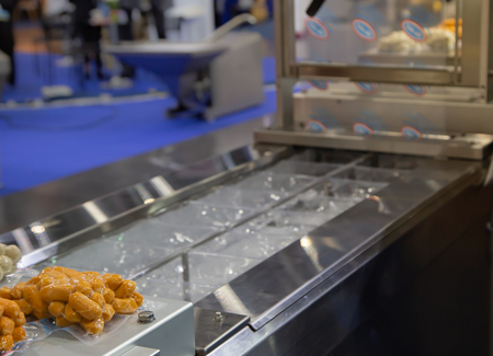 Vacuum packing food sausage in production lineの写真素材