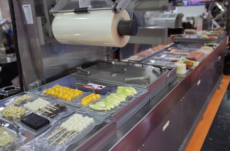 Linear tray food heat sealing and packaging machineの写真素材
