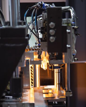 Raw material of PET plastic bottle on blowing machine pre-heat processの写真素材