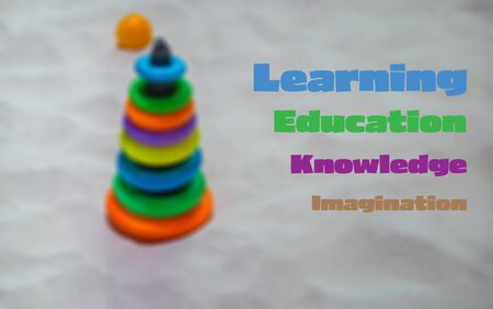 Education learning words on blurred background of plastic cone toy on the beach