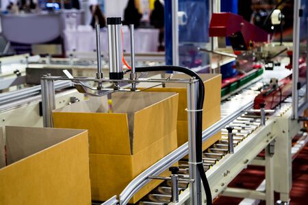 Automatic cardboard box packing and tape sealing machineの写真素材