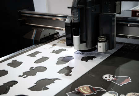 Digital cutting machine cutting cartoon graphic design on ABS plastic sheet