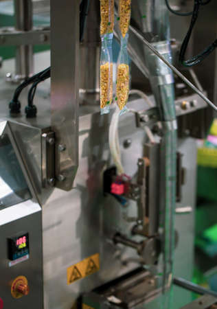 Automatic food packaging vertical filling and sealing machine. Industrial food machinery