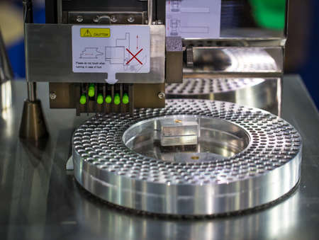 Capsule filling and packing machine in pharmaceutical manufacturing factory.