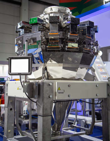 Automated combination weighing. Multihead weighers machine in food industry