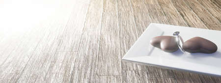 Two heart shaped chocolate on white square dish with engagement ring. Concept for lover in Valentine's day with copy space. 3D rendering imageの写真素材