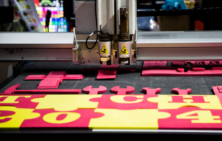 CNC laser cutting machine cutting car carpet mat and engine gasket. Industrial manufacturingの写真素材